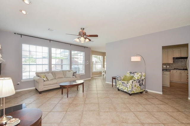 living room featuring ceiling fan and light tile patterned flooring