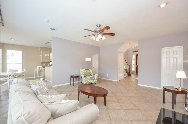 tiled living room with ceiling fan and plenty of natural light