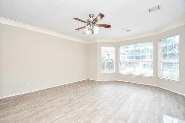 spare room featuring light hardwood / wood-style floors, crown molding, and ceiling fan