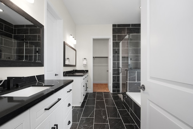 bathroom with vanity and shower with separate bathtub