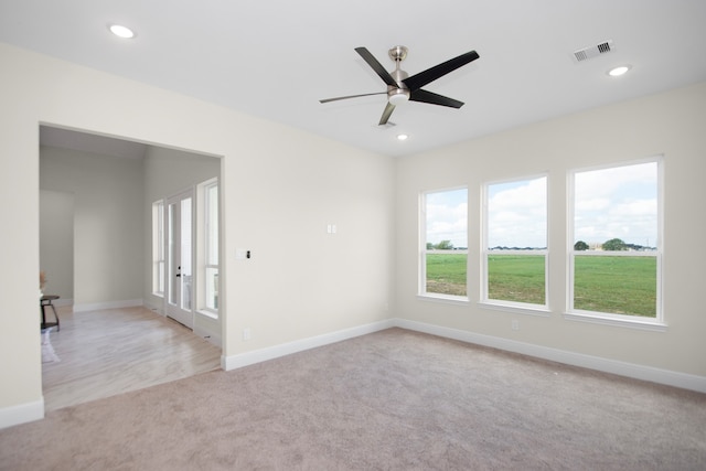 carpeted empty room featuring ceiling fan