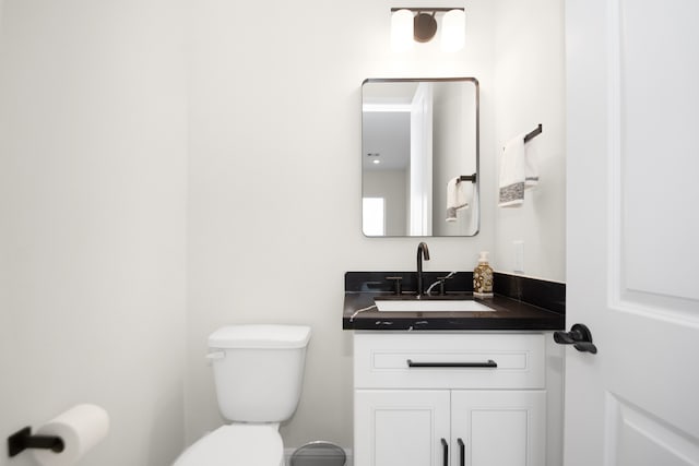 bathroom with toilet and vanity