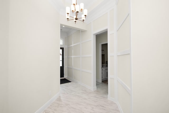 hallway featuring a chandelier and crown molding