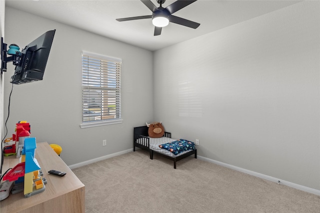 recreation room with ceiling fan and light colored carpet