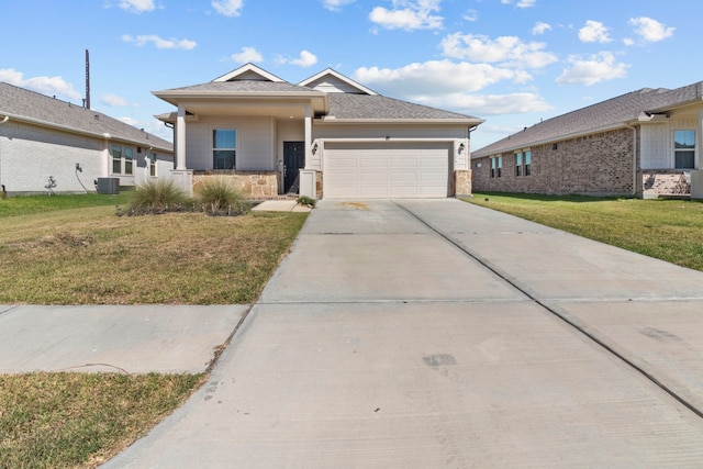 view of front of house featuring a garage, a front lawn, and central air condition unit