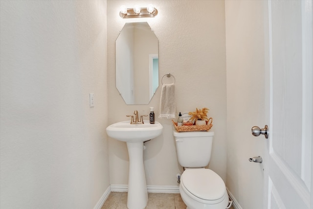 bathroom featuring tile patterned flooring and toilet