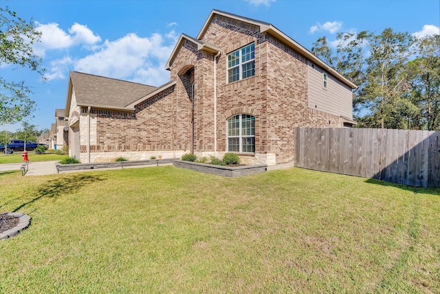 view of side of home with a lawn