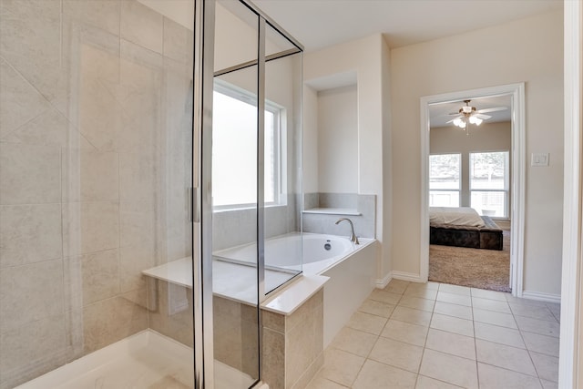 bathroom featuring ceiling fan, shower with separate bathtub, and tile patterned flooring