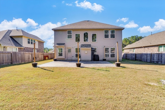 rear view of house with a yard and a patio area