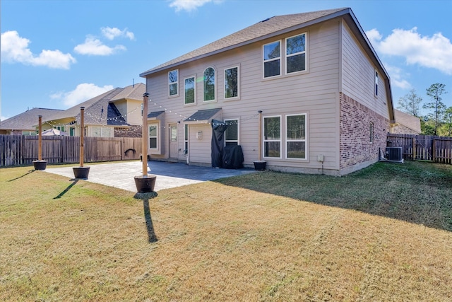 back of house with a lawn, a patio, and central AC unit