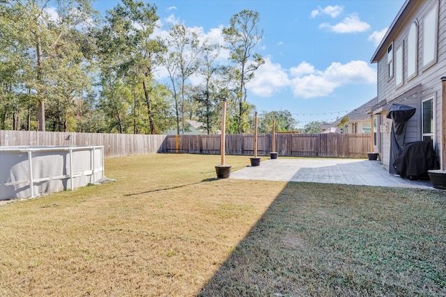 view of yard with a fenced in pool and a patio