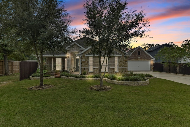 craftsman inspired home with a lawn and a garage