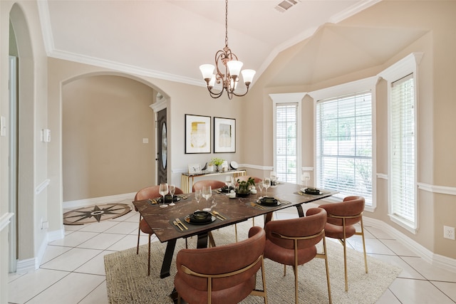 tiled dining space featuring ornamental molding and a chandelier