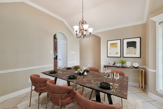 dining room with light tile patterned floors, an inviting chandelier, crown molding, and vaulted ceiling