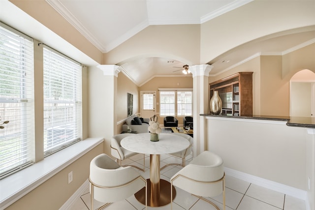 dining area with vaulted ceiling, light tile patterned floors, ornate columns, ceiling fan, and ornamental molding