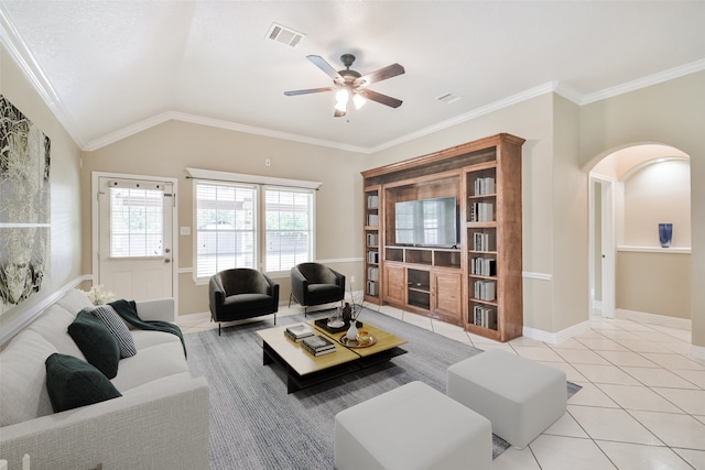 living room featuring ceiling fan, light tile patterned flooring, lofted ceiling, and crown molding