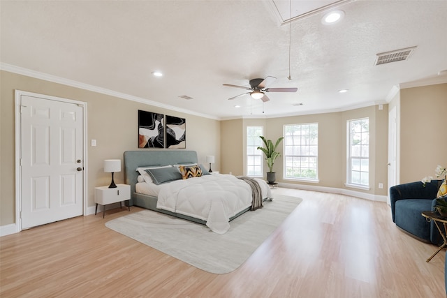 bedroom with ceiling fan, ornamental molding, a textured ceiling, and light hardwood / wood-style floors