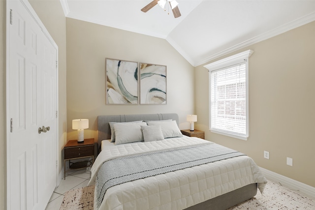 tiled bedroom featuring ceiling fan, ornamental molding, and vaulted ceiling