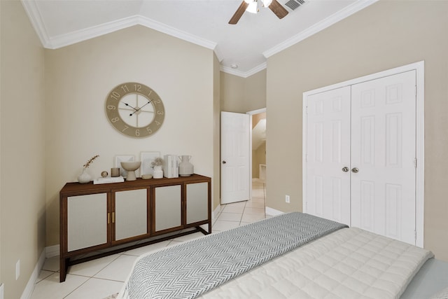 tiled bedroom with crown molding, lofted ceiling, ceiling fan, and a closet