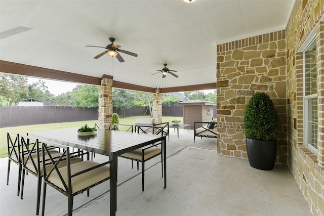 view of patio / terrace with a storage unit and ceiling fan