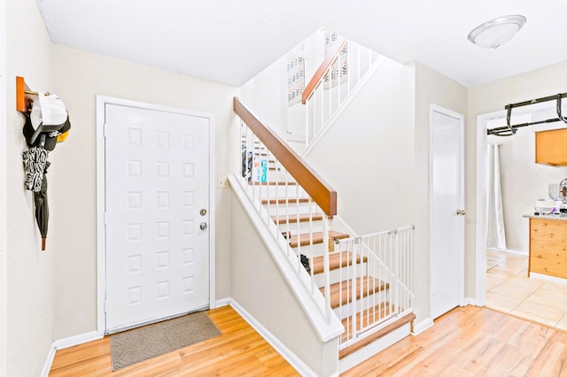 entryway with hardwood / wood-style floors