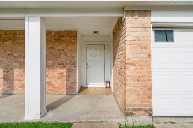 view of exterior entry with a garage