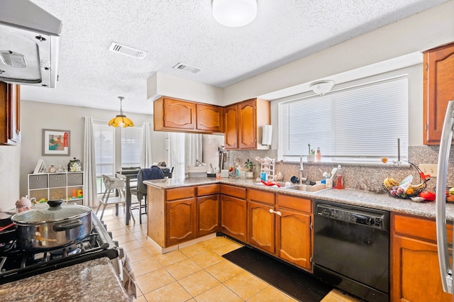 kitchen featuring pendant lighting, black dishwasher, sink, decorative backsplash, and light tile patterned floors