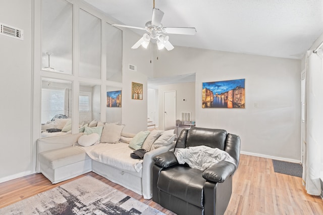 living room featuring high vaulted ceiling, ceiling fan, and light hardwood / wood-style flooring