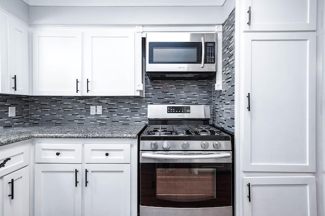 kitchen with white cabinetry, stone counters, tasteful backsplash, and appliances with stainless steel finishes
