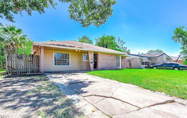 ranch-style home with concrete driveway and a front lawn
