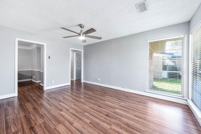 unfurnished bedroom featuring visible vents, baseboards, wood finished floors, and a textured ceiling