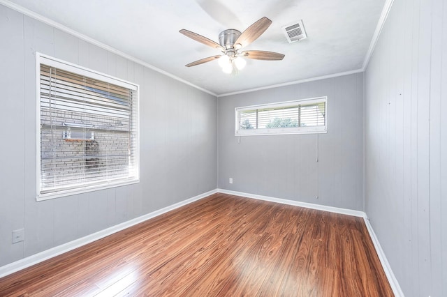 unfurnished room featuring crown molding, visible vents, ceiling fan, and wood finished floors