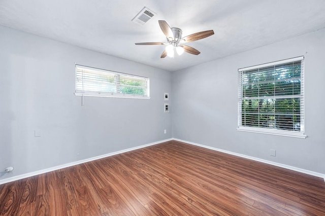unfurnished room featuring visible vents, baseboards, a ceiling fan, and wood finished floors