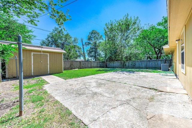 view of patio / terrace featuring a storage shed, an outbuilding, a fenced backyard, and central AC unit