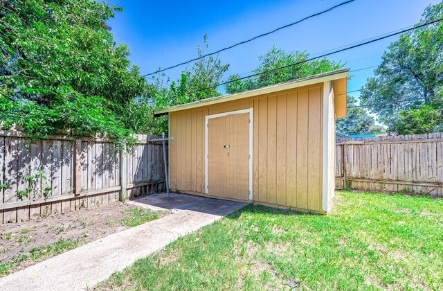 view of shed with a fenced backyard