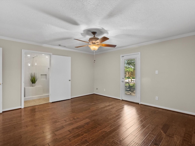 empty room with a textured ceiling, crown molding, and dark hardwood / wood-style floors