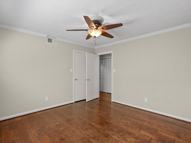 spare room with ceiling fan, dark hardwood / wood-style flooring, and crown molding