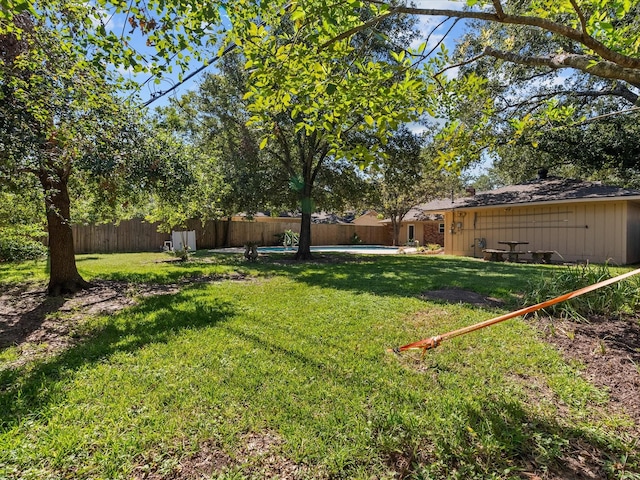 view of yard with a fenced in pool