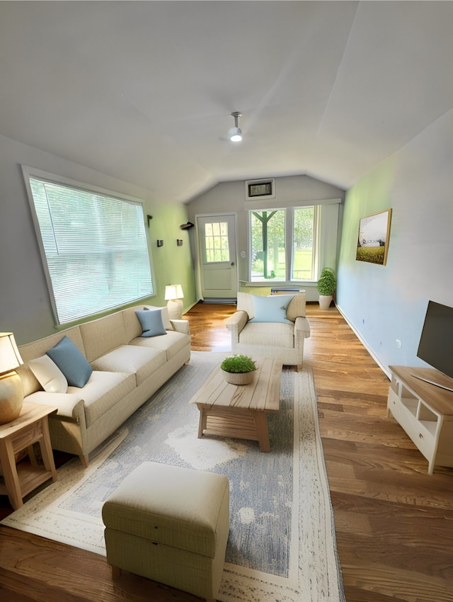 living room featuring vaulted ceiling and hardwood / wood-style floors