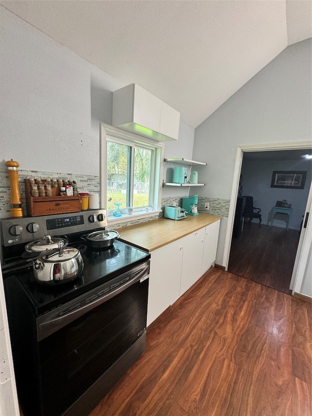 kitchen with white cabinets, lofted ceiling, electric range, and dark wood-type flooring