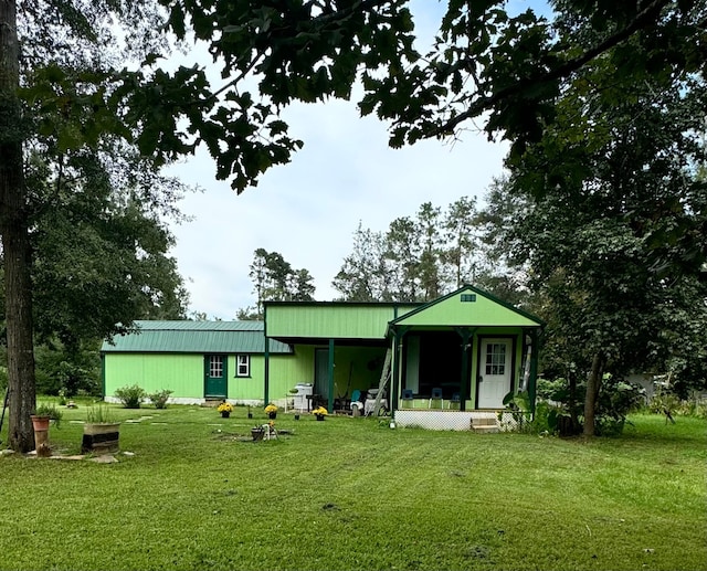 rear view of property featuring a yard