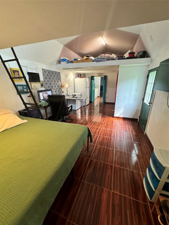 interior space featuring lofted ceiling and white fridge