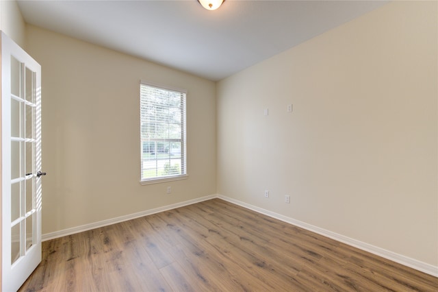 empty room with hardwood / wood-style flooring