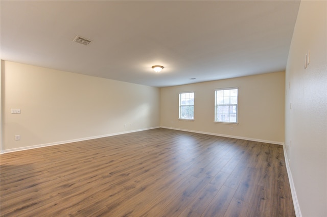 spare room with dark hardwood / wood-style floors