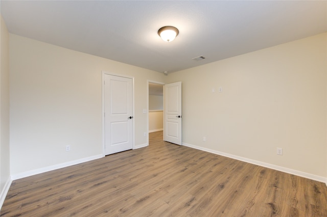 spare room with wood-type flooring