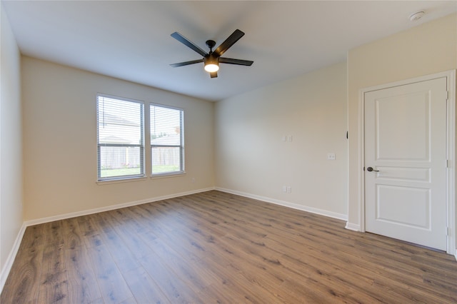 spare room featuring dark hardwood / wood-style flooring and ceiling fan