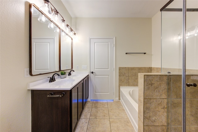 bathroom featuring vanity, tile patterned floors, and a bathing tub