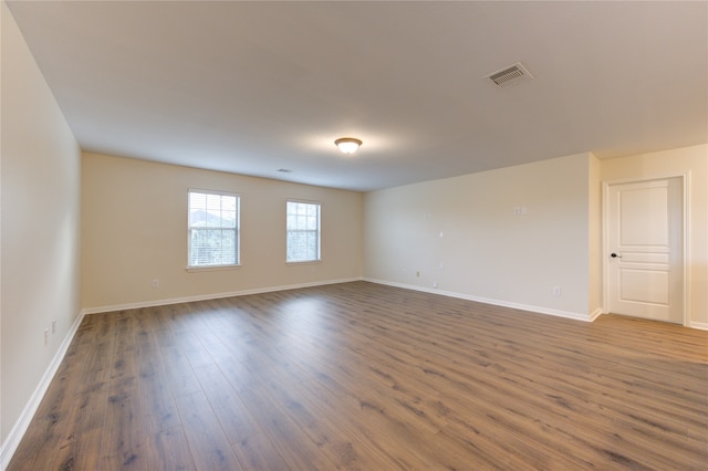 unfurnished room with dark hardwood / wood-style floors