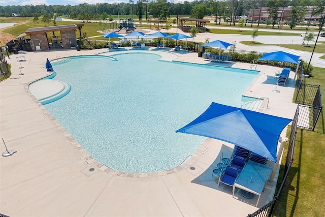 view of pool with a patio area and fence