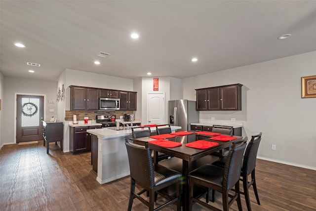 dining space featuring dark wood-type flooring and sink